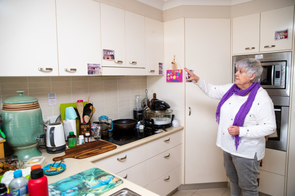 Bobby Redman uses timers in her kitchen and photos of where things belong to prompt her memory. 