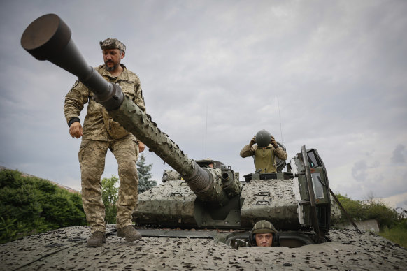 Ukrainian soldiers on a Swedish CV90 infantry fighting vehicle at their positions near Bakhmut,