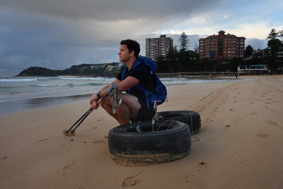 Gareth Andrews on Manly Beach takes a break during training ahead of  The Last Great First, a 110-day trek across Antarctica.