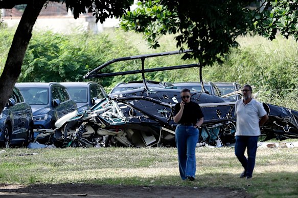 Helicopter wreckage at a car dealership yard where, according to police, two helicopters collided in midair and crashed in Rio de Janeiro.