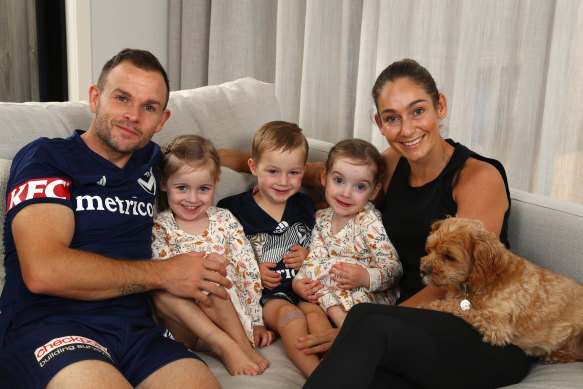 Leigh Broxham, left, with his wife, Sam, right, and their triplets. 