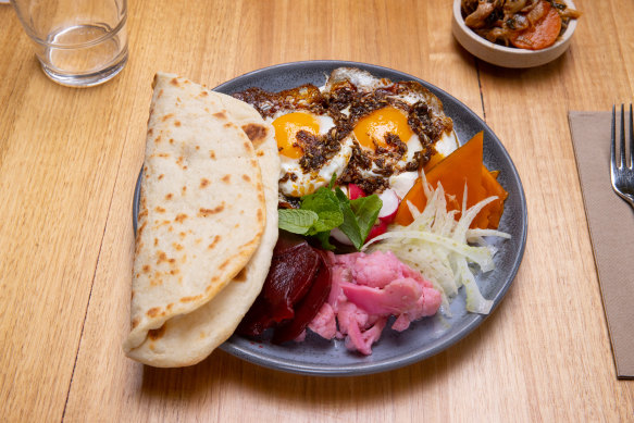 Cassette’s levantine mezze: shanklish yoghurt, two fried eggs with chilli oil, seaso<em></em>nal vegetables and whey flatbread.