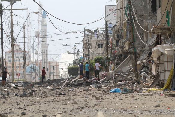 Palestinian citizens inspect damage to their homes caused by Israeli airstrikes in Gaza.