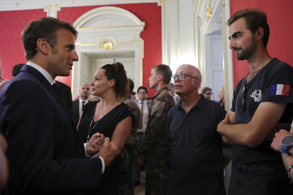 Henri, right, meets French President Emmanuel Macron in Annecy. The 24-year-old man in France is being hailed as a hero after he intervened in a savage knife attack on very young children. 