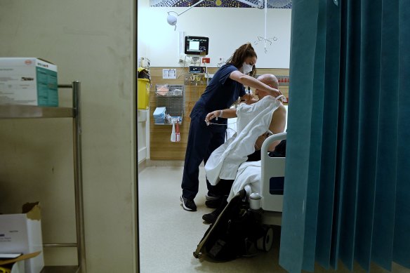 A registered nurse tends to a patient in the emergency rooms at St Vincent’s Hospital.