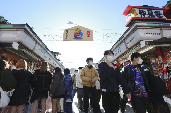 People wearing face masks walk through Nakamise in Tokyo this week.
