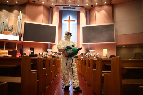A worker disinfects a church in Seoul, South Korea, amid fears of an outbreak there.