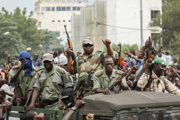 Crowds cheer as soldiers parade in vehicles along the Boulevard de l'Independance in Bamako, Mali on Tuesday.