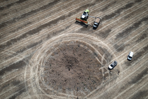 A farmer collects his harvest around a crater left by the Russian rocket on a field 10 kilometres from the battle’s frontlines, in the Dnipropetrovsk region, Ukraine. 