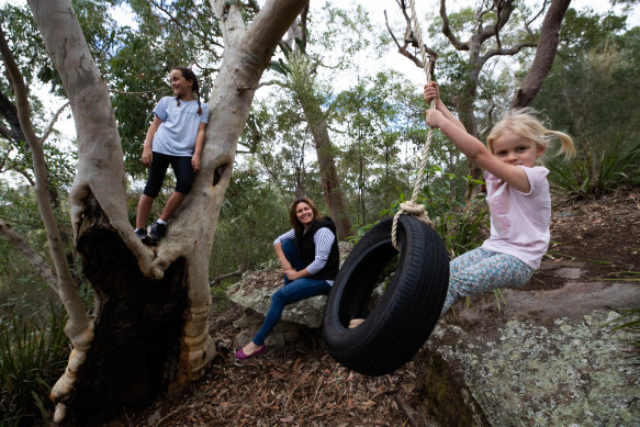 Rachel Chappell with daughters Ella (on swing) and Scarlett playing in their backyard on their new tyre swing.