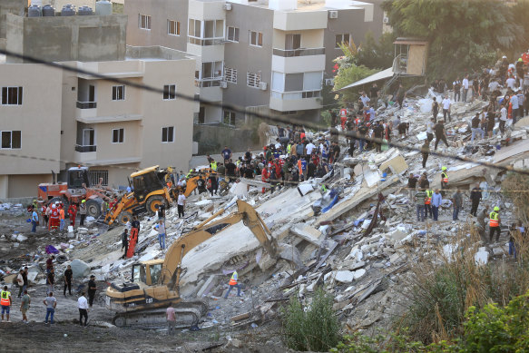 People and rescue teams search for victims after an Israeli airstrike hit two adjacent buildings, in Ain el-Delb neighbourhood east of the southern port city of Sidon, Lebanon.