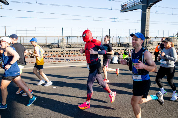 A competitor dressed as Spider-Man weaves his way along the Harbour Bridge.
