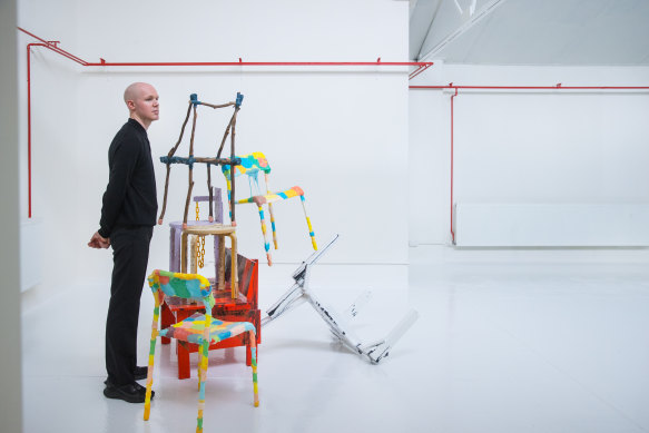 Designer Dale Hardiman with his assembly of chairs.