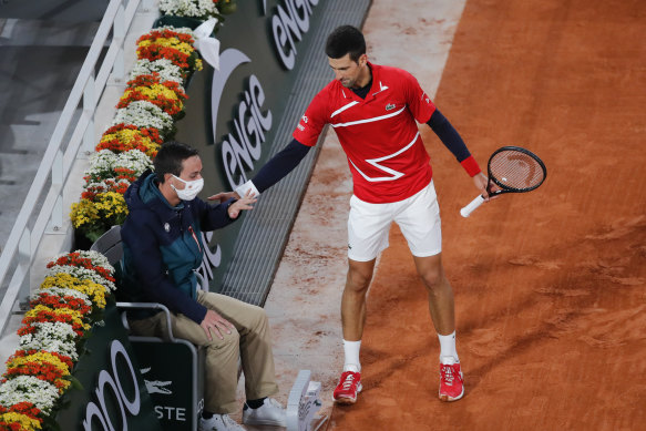 Novak Djokovic checks on the linesman after the ball spun off his racquet and hit the official.