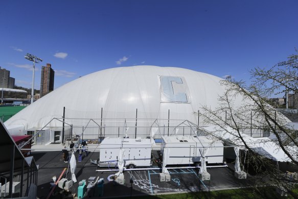 Workers build a medical facility in New York, which will have the capacity to care for up to 288 high-acuity COVID patients.