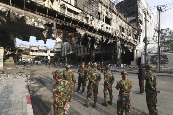 Cambodian military personnel stand guard at the scene of the massive fire in Poipet.