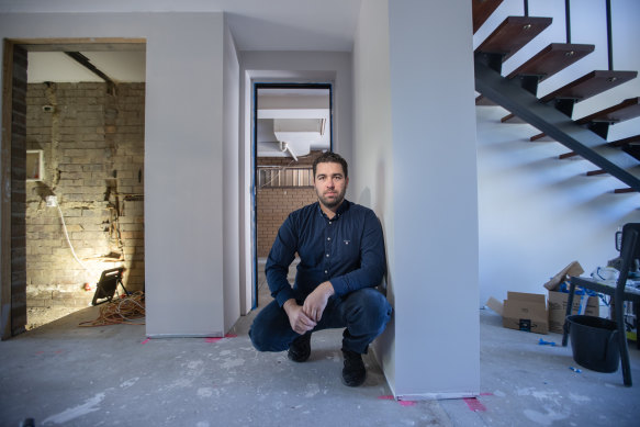 Lee Lanzafame at his Maribyrnong home. One year on from the floods, the ground level is still not repaired.