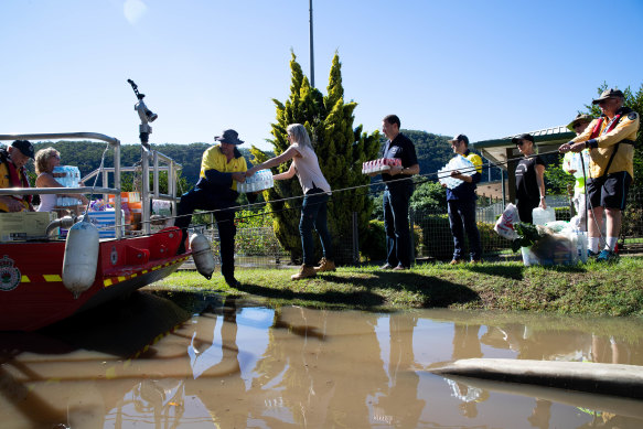 The community drops off supplies for the RFS to transport by boat to isolated communities stranded by the rising floodwaters at Wisemans Ferry. 