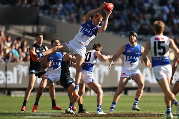 Toby Pink flying high for North Melbourne in an AFL game last year.
