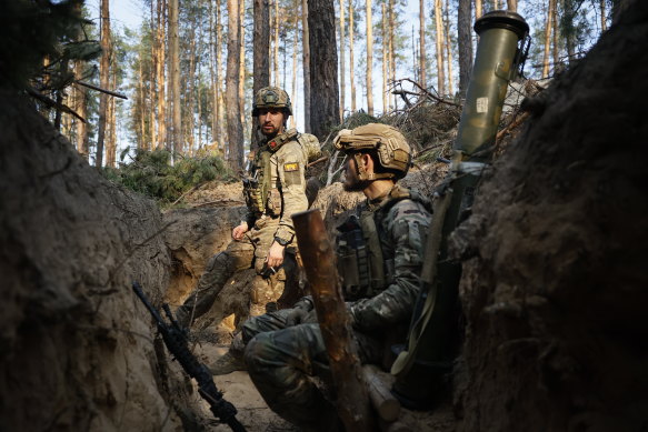 Ukrainian soldiers rest in a trench on the frontline near Kreminna, Luhansk region.
