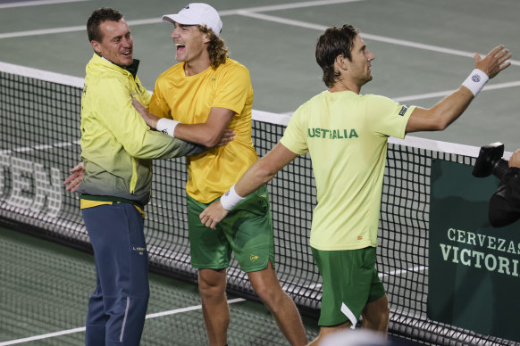 Australian captain Lleyton Hewitt celebrates with Matt Ebden (right) and Max Purcell after victory over France.