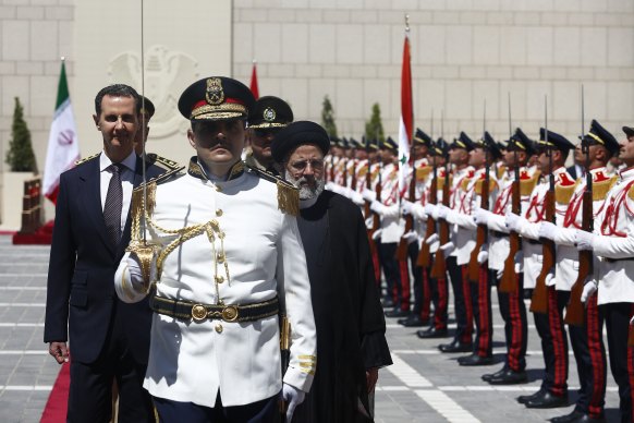 Syrian President Bashar al-Assad welcomes Iranian President Ebrahim Raisi at the Presidential Palace in Damascus last week.