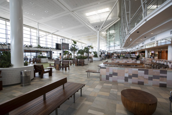 Brisbane Airport's terminals are deserted, but planes filled with freight are still taking off.