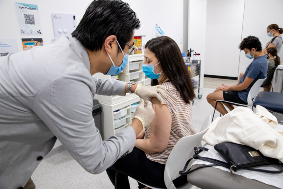 Dr Eric Chan gives Elena Stefanovski her second dose of Pfizer on Sunday. 