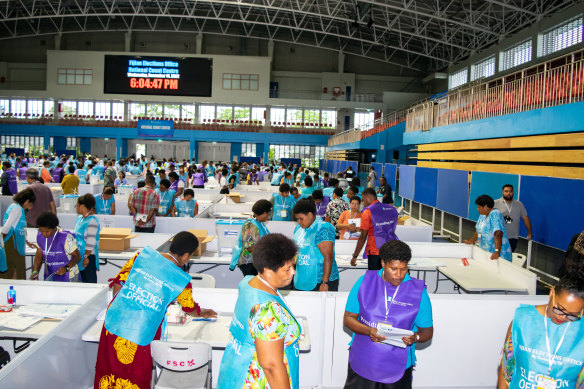 Election workers count votes at the National Counting Center in Suva on December 14.