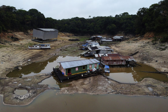 Boats and houseboats are stuck in a dry area of the Negro River during a drought in Manaus, Amazonas state, Brazil.