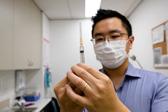 Lindfield GP Dr Chris Lee with a syringe of the AstraZeneca vaccine. GPs are being underutilised in the rollout.