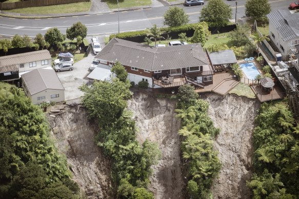 A house perched on the cliffs of Massey in Auckland after heavy rain washed the edge of the cliff.