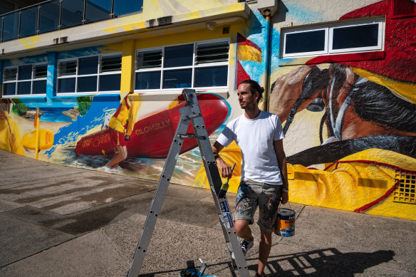 Award-winning artist Matt Adnate in front of his mural at Clovelly Surf Life Saving Club.