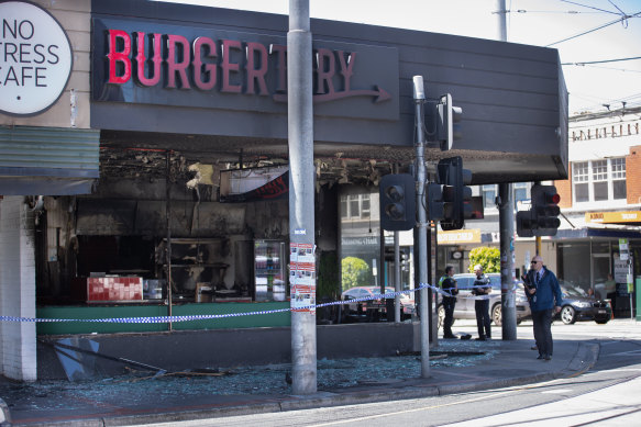 Victoria Police detectives at the scene of the destroyed Burgertory outlet.