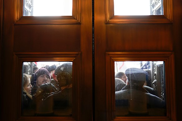 US Capitol Police try to hold back rioters. 