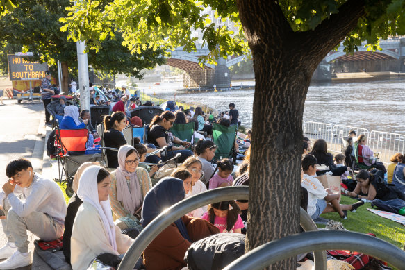 People find a spot along the Yarra waiting for New Year’s Eve fireworks. 