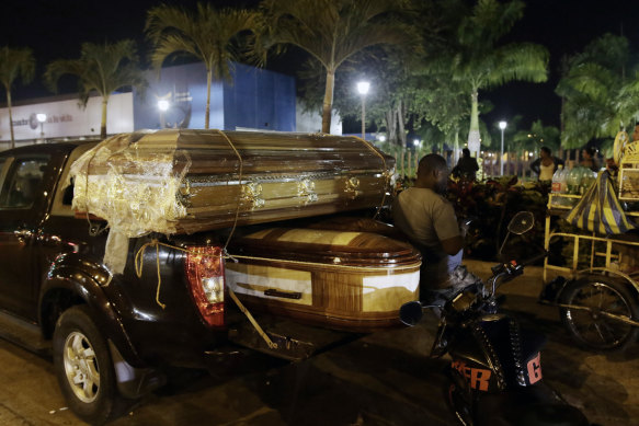 Coffins for the bodies of inmates sit on a truck outside the Guayaquil morgue.