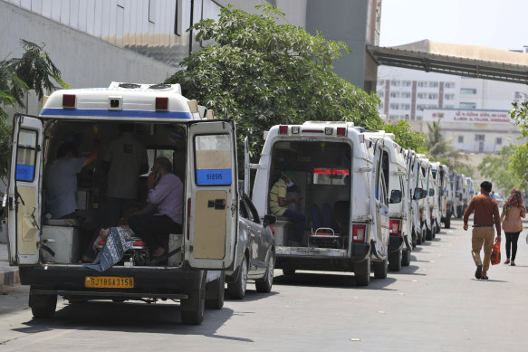 Ambulances line up waiting for their turn to deliver patients to a dedicated COVID-19 hospital in Ahmedabad, India.