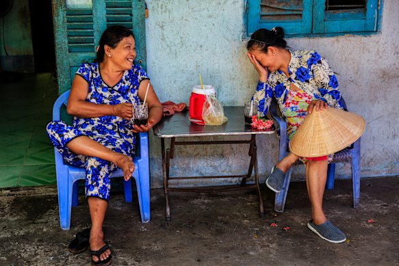 Women share a coffee in the Mekong River Delta, Vietnam.
