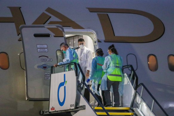 Australian biosecurity staff enter a tennis charter flight in Melbourne on Friday.