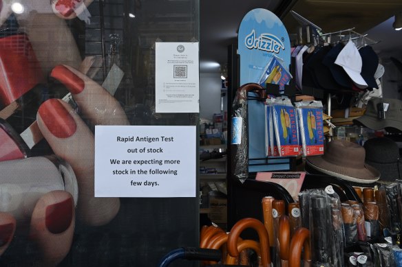 A sign in the window of a pharmacy at Circular Quay alerting customers that it has run out of stock of rapid antigen test kits.