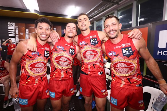 Malcolm Rosas, Daniel Rioli, Joel Jeffrey, Ben Long of the Suns celebrate after their win over Hawthorn.