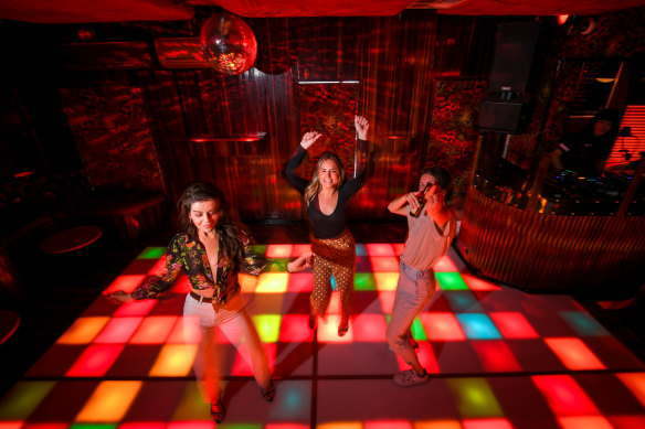 Alyce Merrilees, centre, with friends Eliza Hilmer and Christina Mcdonald will be back on the dance floor at OneSixOne nightclub when it reopens.