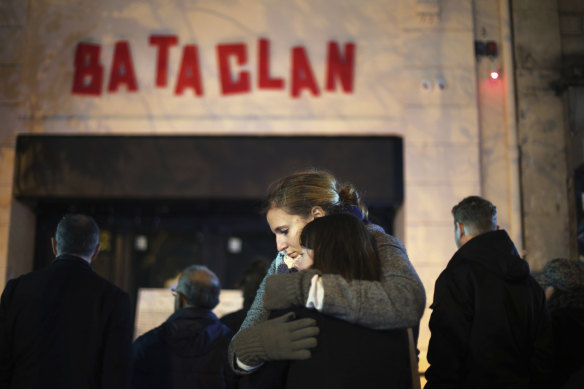 Women hug in front of the Bataclan concert hall in Paris, weeks after the attack.