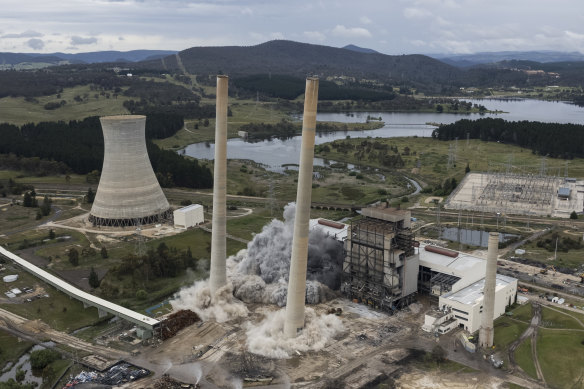 Going: The chimneys begin to fall in a controlled demolition.