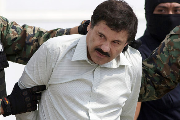 Sinaloa cartel leader Joaquin “El Chapo” Guzman is escorted to a helicopter in Mexico City following his capture.