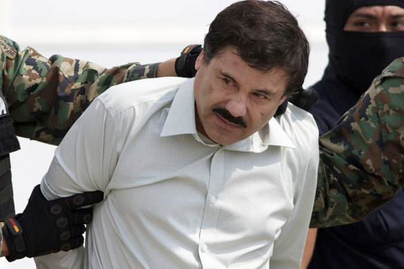 Joaquin “El Chapo” Guzman, the then-head of Mexico’s Sinaloa Cartel, is escorted to a helicopter in Mexico City following his capture  in 2014.