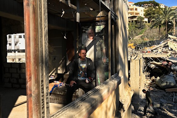 Samer al Nassar sits in front of a portrait of his father in his home that was damaged when his neighbour’s house was destroyed by an Israeli airstrike in Ghaziyeh on March 8.