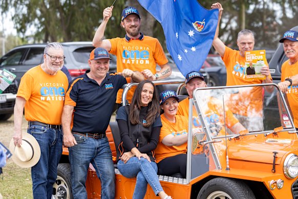 Matthew Collins (waving the flag) with One Nation members during the Nepean byelection earlier this year.