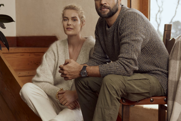 She wears: Friends with Frank “Agnes” cardigan, $359, and “Tapered” pants, $389; and Oroton “Maisie” bracelet, $250. He wears: Country Road jumper, $149; Polo Ralph Lauren pants, $259; R.M. Williams “Rigger Commando” boots, $695; and Omega watch, $17,325. Also shown: The Grampians Goods Co blanket, $179.